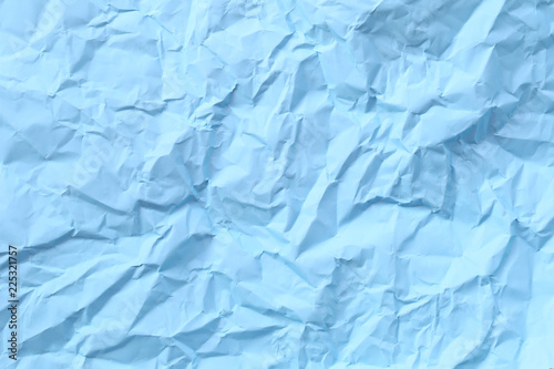 blue arctic color of crumpled or wrinkled paper background.