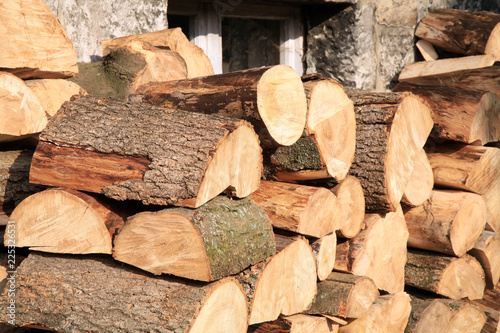 Pile of firewood. Preparation of firewood for the winter at an old farm house on the farm.