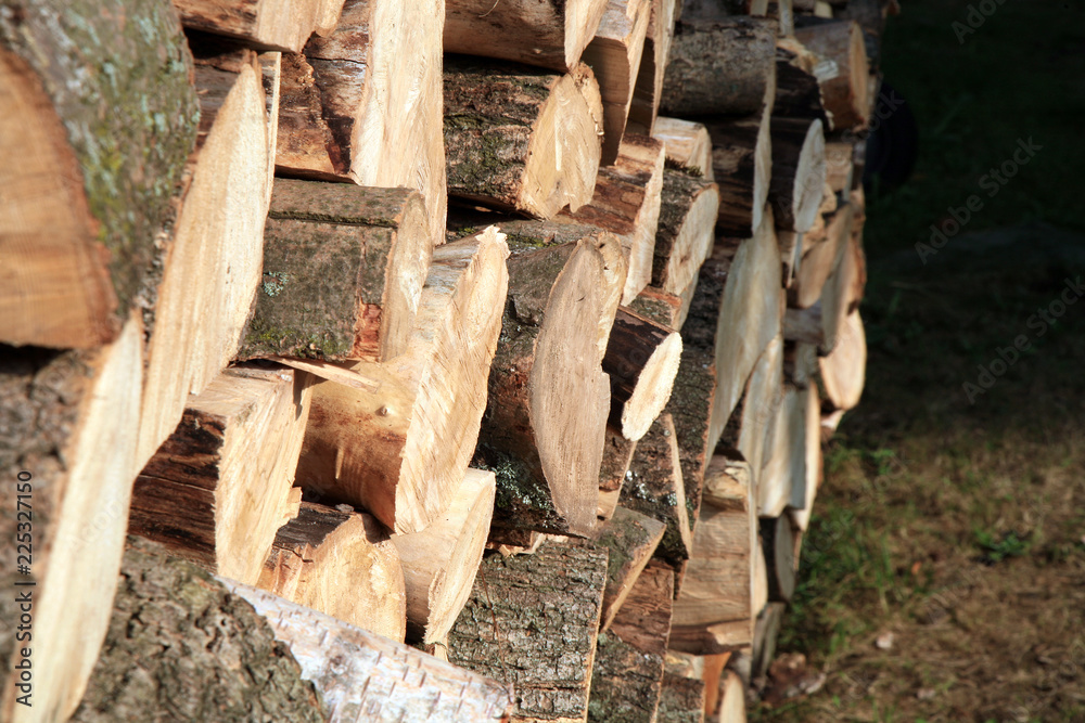 Pile of firewood. Preparation of firewood for the winter at an old farm house on the farm. Pile of firewood. Preparation of firewood for the winter at an old farm house on the farm.