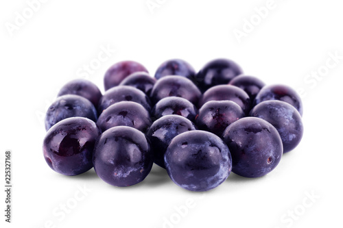 Fresh little plums on a white background
