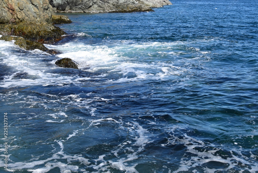 rugged shoreline blue ocean surface with light surf swell rugged shoreline blue ocean surface with light surf swell
