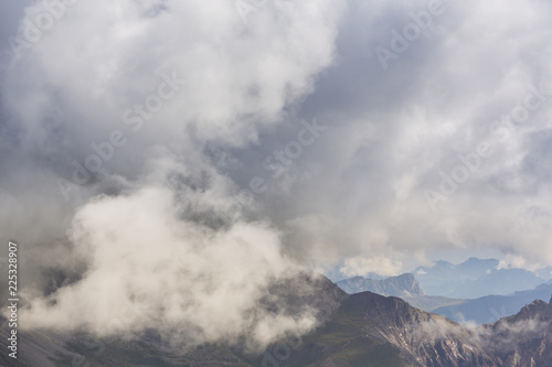 Mountain scenery in the Transylvanian Alps in summer  with mist and rain clouds
