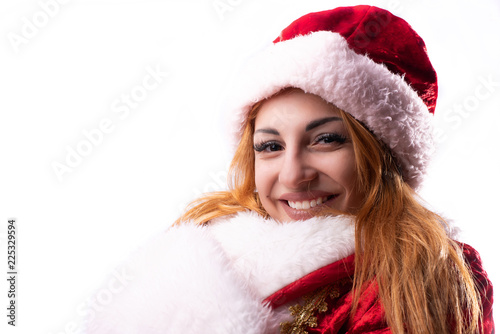 girl with a beautiful smile and red hair in a Santa Claus costume