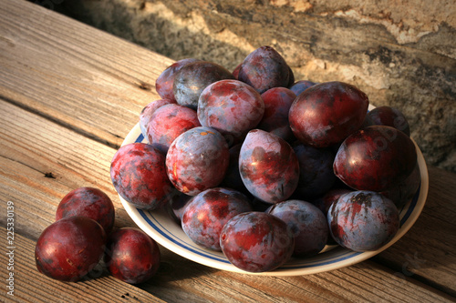 Plums from home orchard. Tasty and healthy snack on the farm. Set of fruits in the countryside.