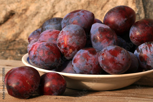 Plums from home orchard. Tasty and healthy snack on the farm. Set of fruits in the countryside.