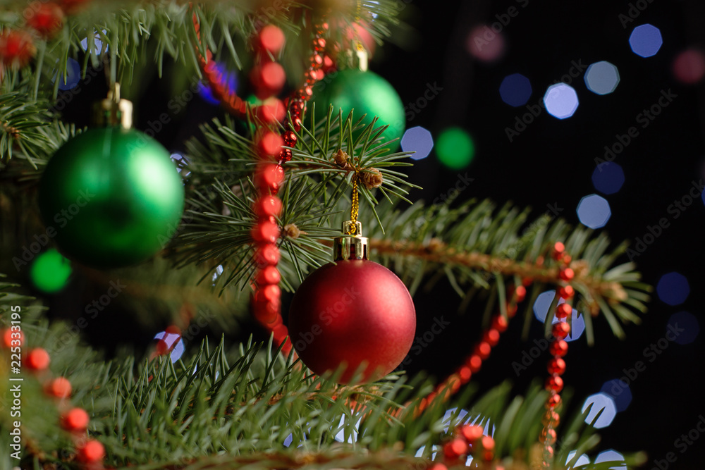 Christmas tree, on the table, against the background of blurry lights, bokeh. The concept of New Year.