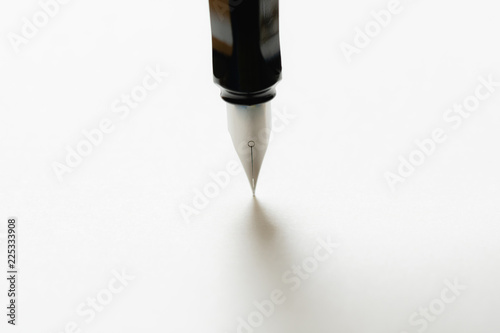 Fountain pen placed on the white paper opaque. Communication to business transactions, education, work, suitable as a background image.