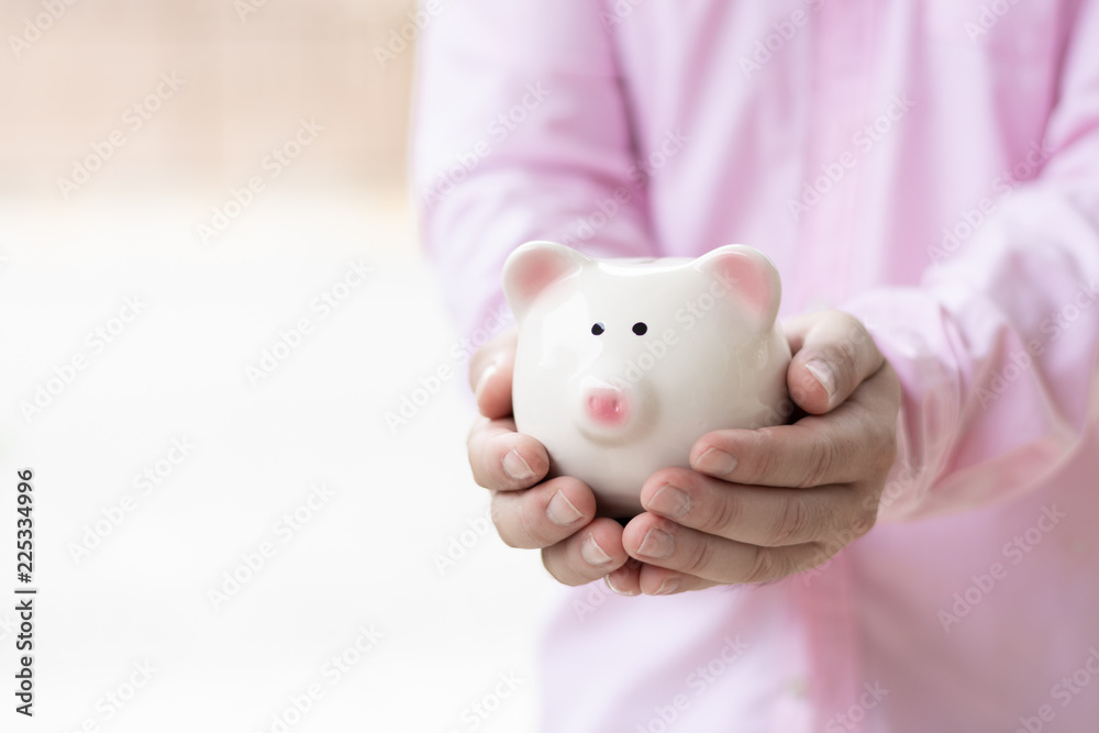 man hand holding pig bank concept saving money and investment for the future and retirement. man hand holding pig bank concept saving money and investment for the future and retirement.