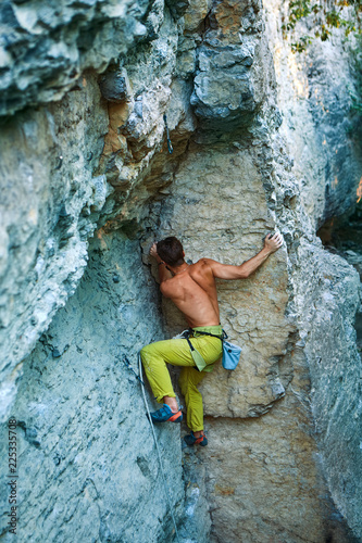 rock climbing. man rock climber climbing the challenging route on the limestone wall