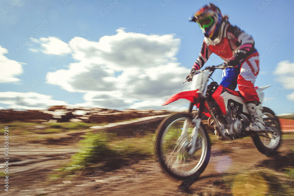 woman on enduro motocross in motion, desire for victory, dynamics of speed