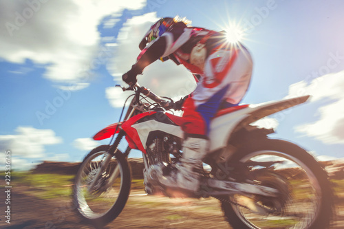 woman on enduro motocross in motion, desire for victory, dynamics of speed