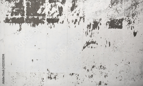 Grungy white painted concrete wall, with white paint peeling off in some