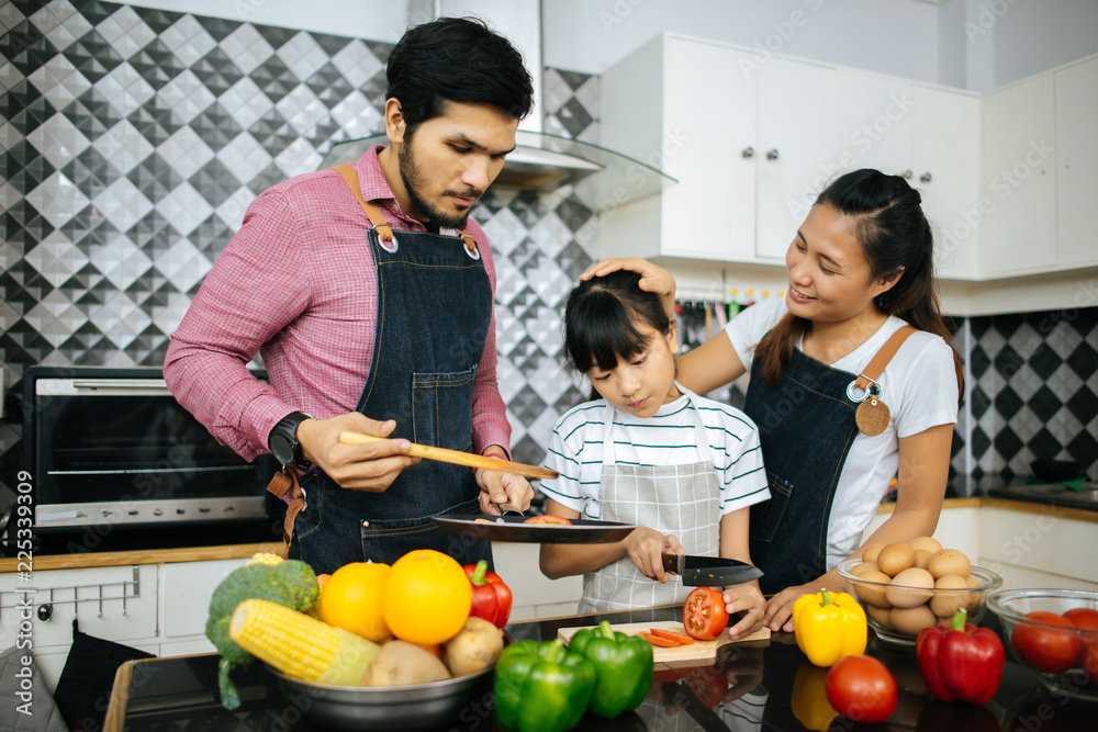 Family cooking time : Happy family help cooking meal together in kitchen at home.. Family cooking time : Happy family help cooking meal together in kitchen at home..
