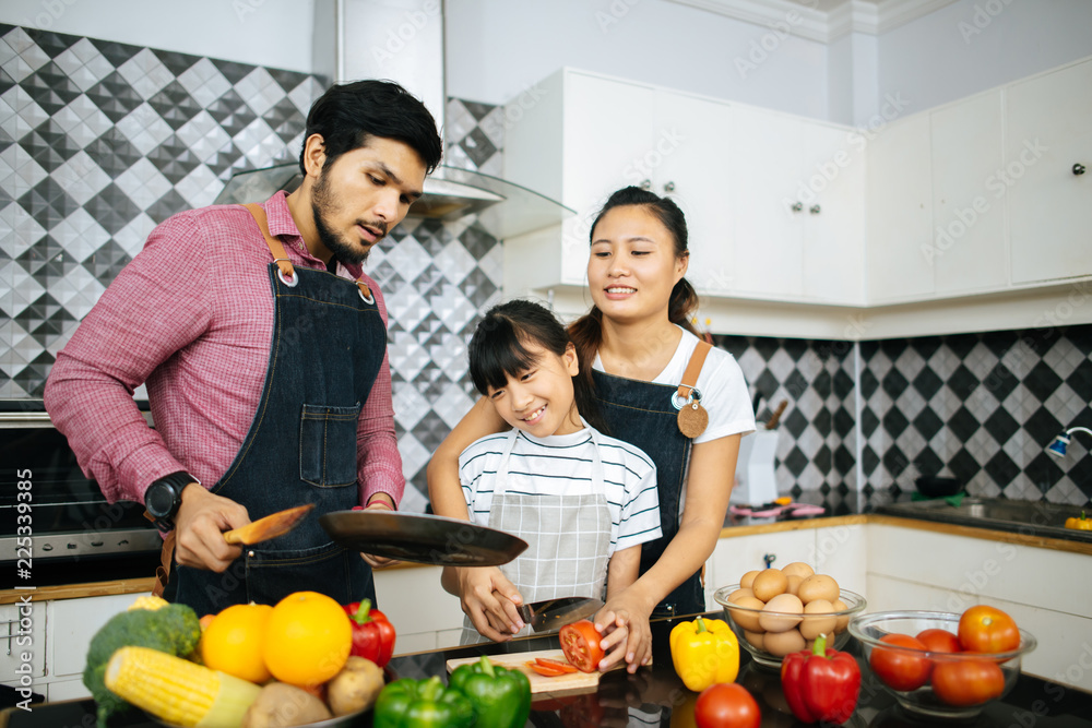 Family cooking time : Happy family help cooking meal together in kitchen at home.. Family cooking time : Happy family help cooking meal together in kitchen at home..