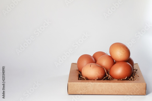 Chicken brown eggs on a white table