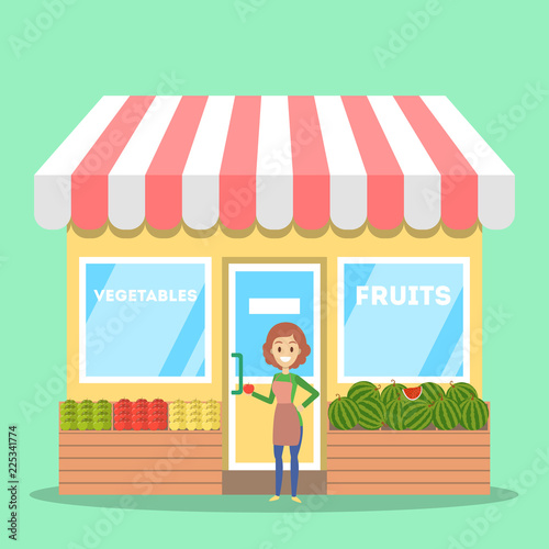 Female seller standing in front of fruit and vegetable store