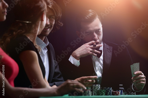 Upper class friends gambling in a casino photo