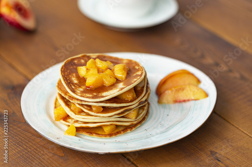 Pancakes with honey and fruit. Delicious breakfast.