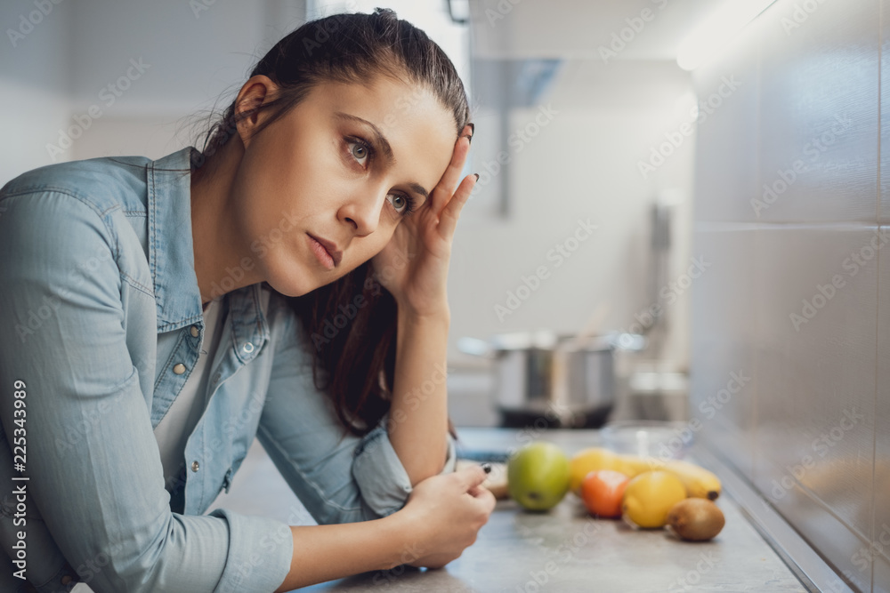Sad girl leaning on the kitchen countertop Sad girl leaning on the kitchen countertop