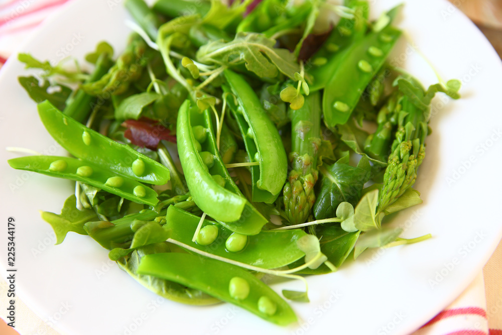Spring salad with asparagus, snap peas and daikon sprouts