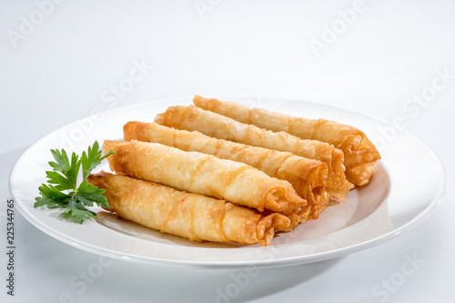 Cigar Pastries on a white plate. photo