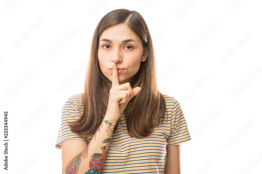 Woman With Finger On Lips Standing Over White Background Woman With Finger On Lips Standing Over White Background
