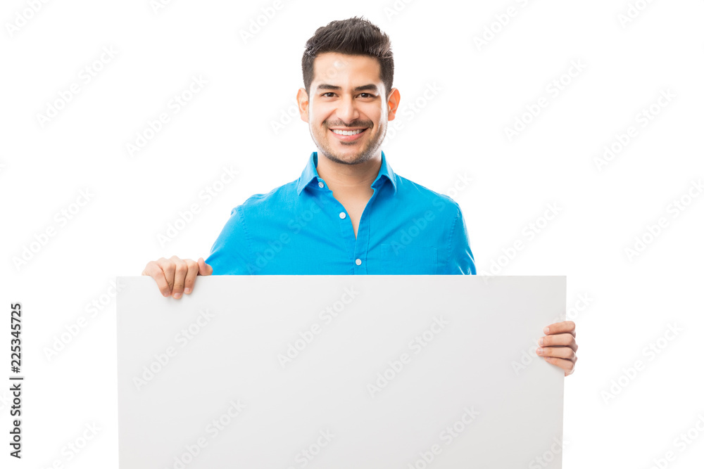 Attractive Male Smiling While Holding Blank Poster Attractive Male Smiling While Holding Blank Poster