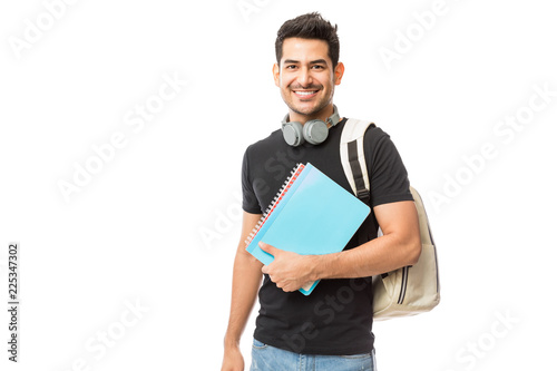 Smiling Young College Student With Books And Backpack photo