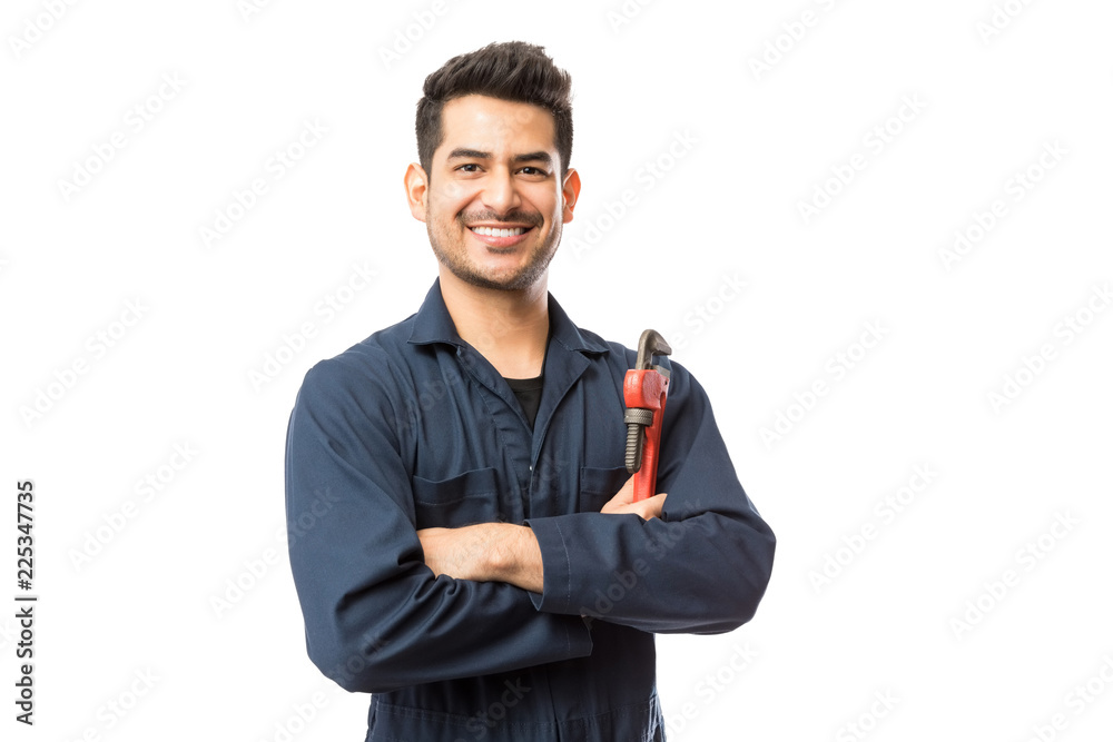 Smiling Male Plumber With Pipe Wrench Standing with Arms Crossed Smiling Male Plumber With Pipe Wrench Standing with Arms Crossed