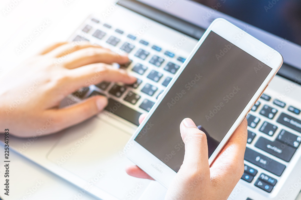 Man's hands holding a credit card and using laptop for online shopping. Man's hands holding a credit card and using laptop for online shopping.