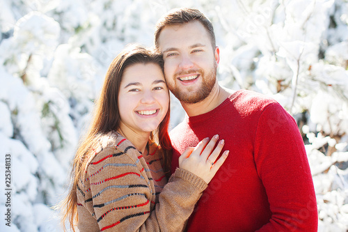 Couple in love in winter forest.