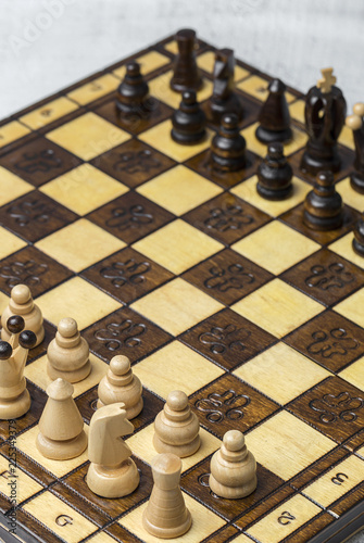 Game and chess pieces on white background