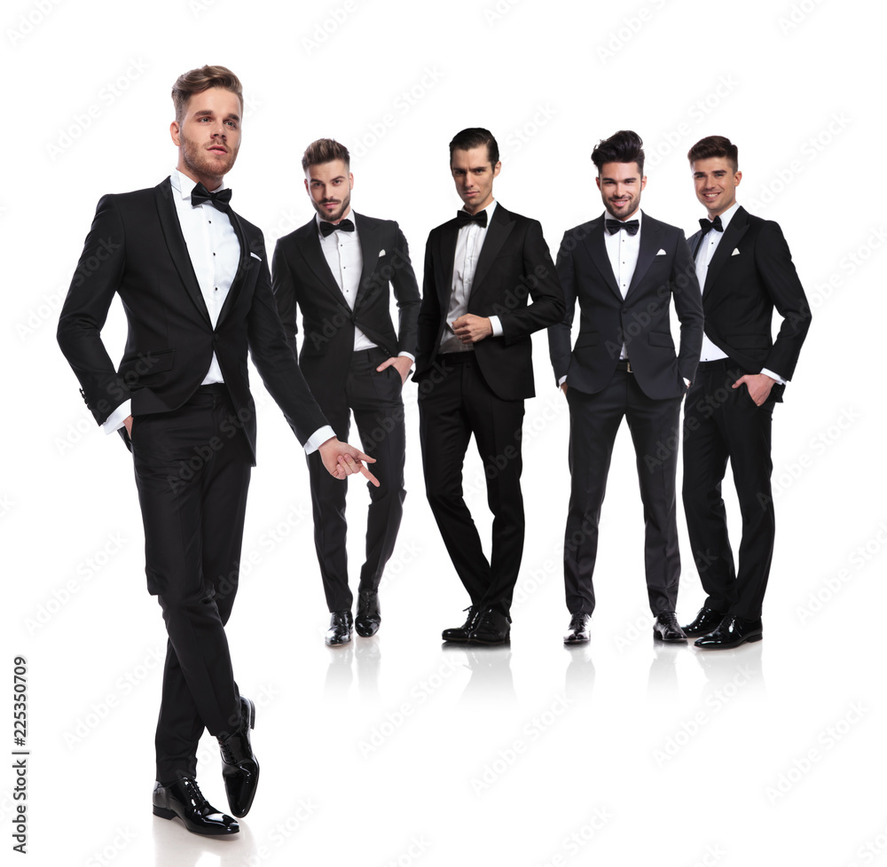relaxed leader standing in front of grooms and snapping fingers relaxed leader standing in front of grooms and snapping fingers