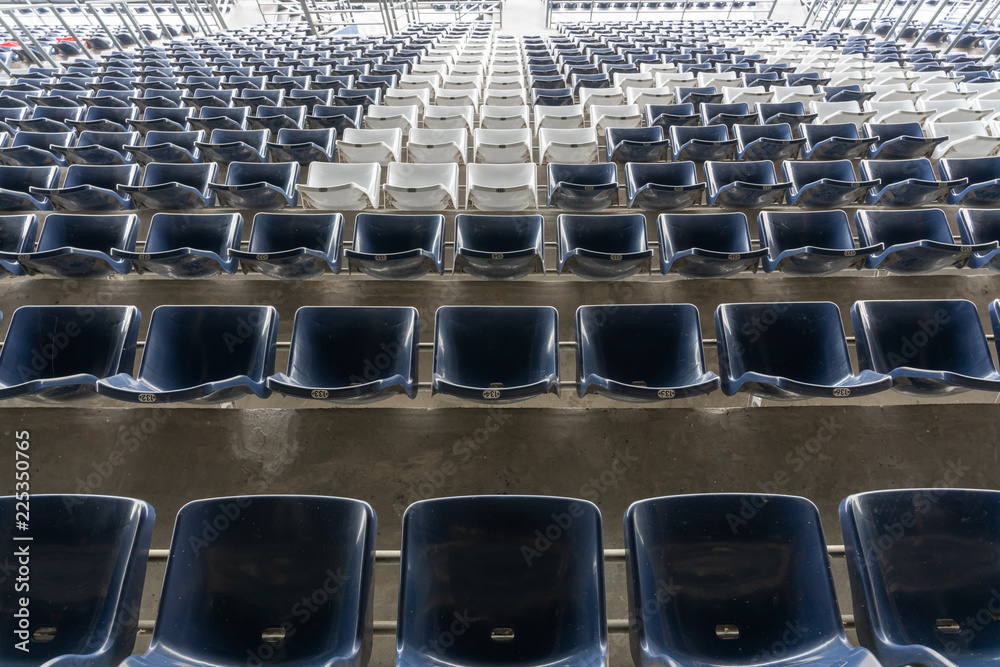 Fototapeta premium empty Rows of stadium grandstand seats or stadium seats, plastic blue and white seats on grand stadium pattern.