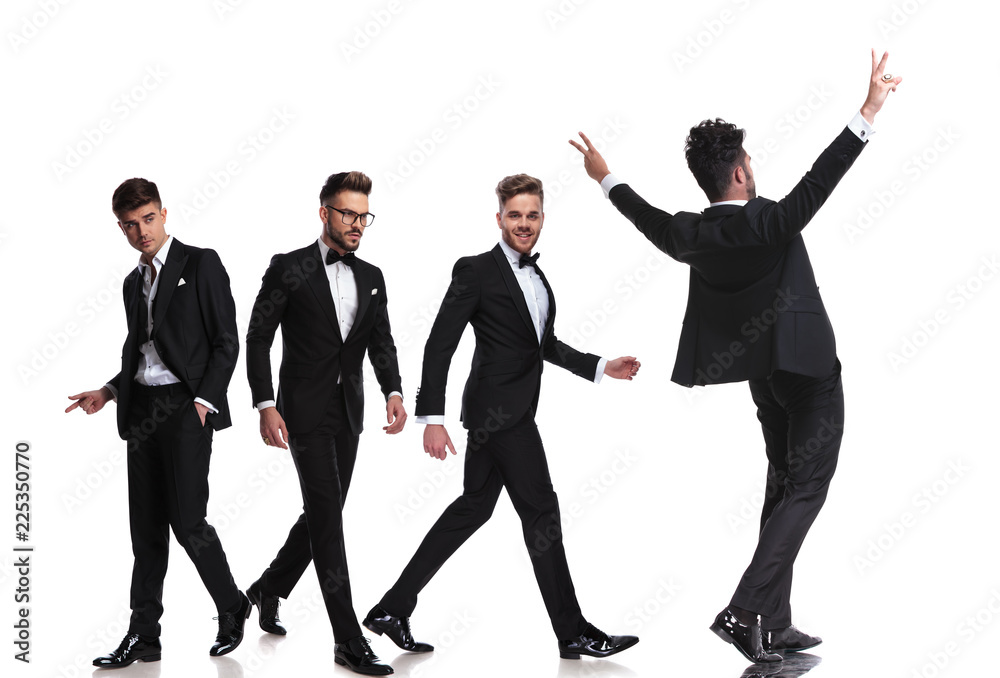 four elegant men in tuxedoes walking in different directions four elegant men in tuxedoes walking in different directions