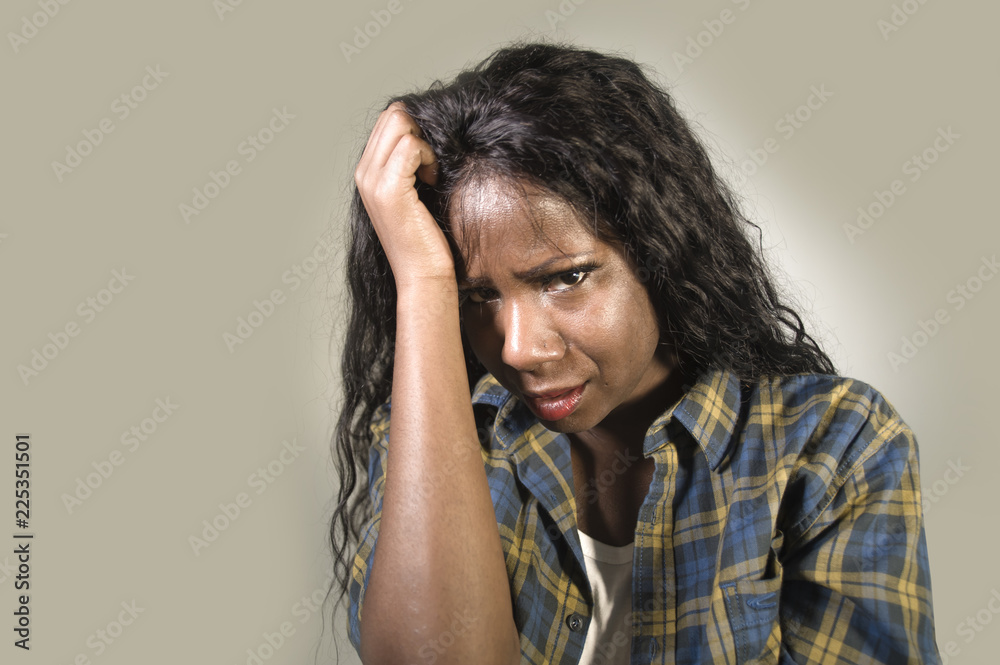 young sad and depressed black African American woman crying anxious and overwhelmed feeling sick and stressed isolated on studio background suffering depression young sad and depressed black African American woman crying anxious and overwhelmed feeling sick and stressed isolated on studio background suffering depression