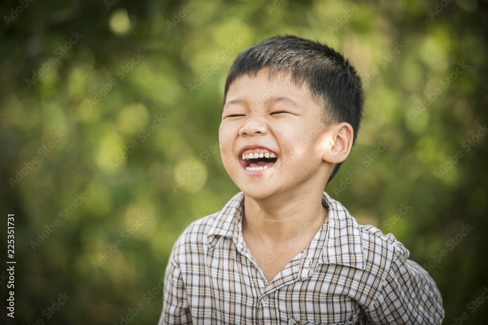 Portrait of happy little boy laughing while he play in the park. Portrait of happy little boy laughing while he play in the park.