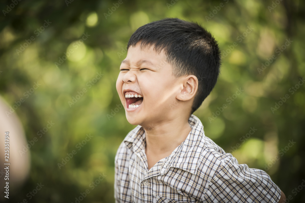 Portrait of happy little boy laughing while he play in the park. Portrait of happy little boy laughing while he play in the park.