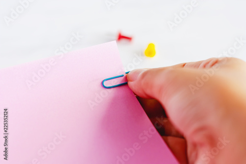 Hand holding several sheets...