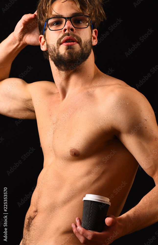 Macho attractive nude guy hold hot coffee. Man smart and sexy with beard  and tousled hair