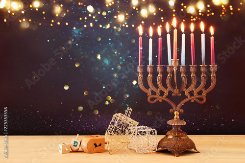 image of jewish holiday Hanukkah background with menorah (traditional candelabra) and burning candles.