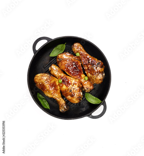 Fried chicken drumstick with sesame in a frying pan