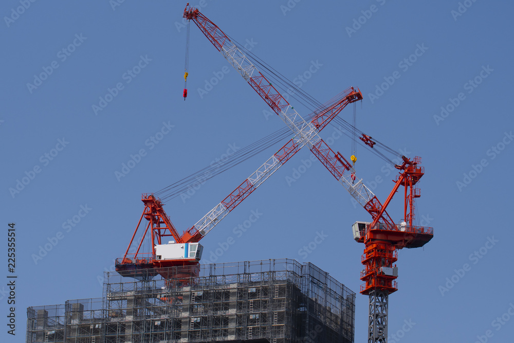 Crane and building construction as industry background.