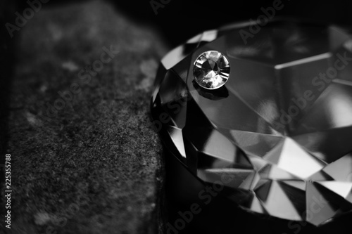 A Single Diamond on Top of a Large Gem Stone, Showing the Facet Cut of the Jewel.