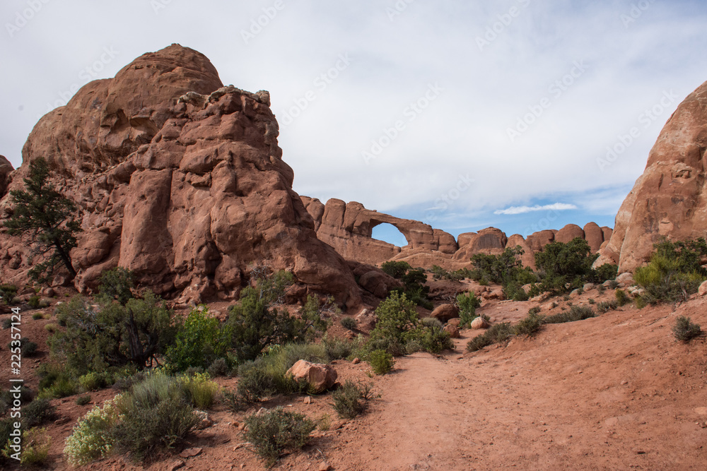 Tourists climb around in an arch inside of Arches National Park in Utah