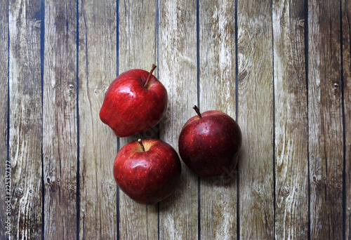 Fresh red apples on the wooden background with sack.Flatlay angle.