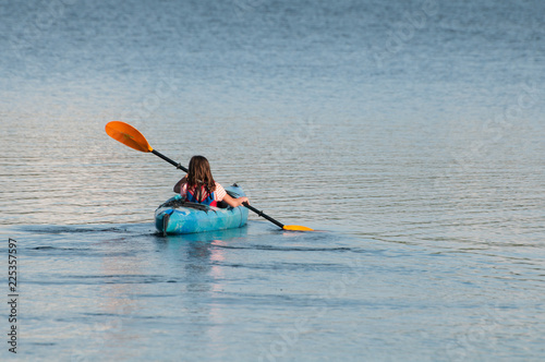 Girl kayaking on a lake