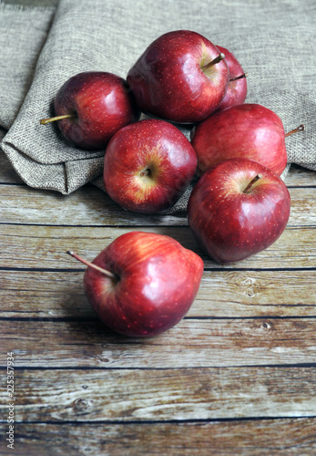 Fresh red apples on the wooden background with sack.selective focus. blurred background