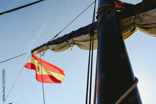 Spanish flag on commercial sailing ship photo