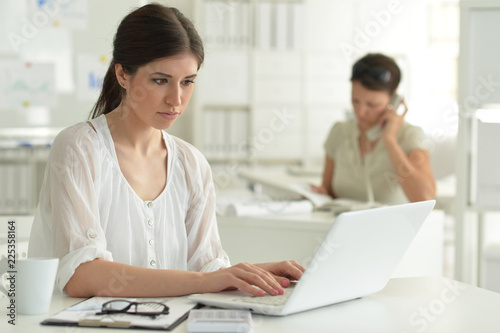 Portrait of young attractive woman working in office